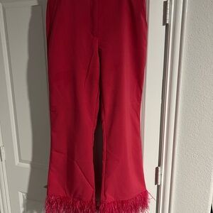 Women pink pants with feathers on the bottom of pants. Fun and unique.